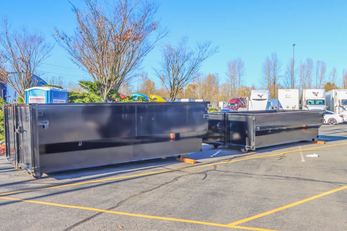 Professional dumpster rental service with roll-off container on residential driveway in Heathrow